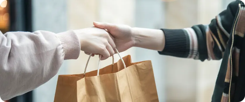 someone giving a paper bag
